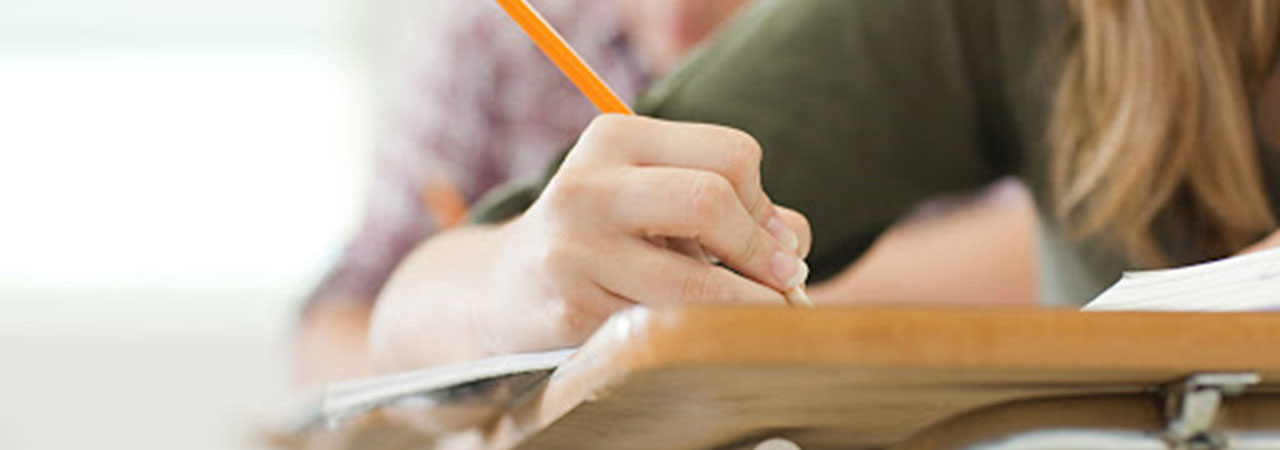 student writing at school desk